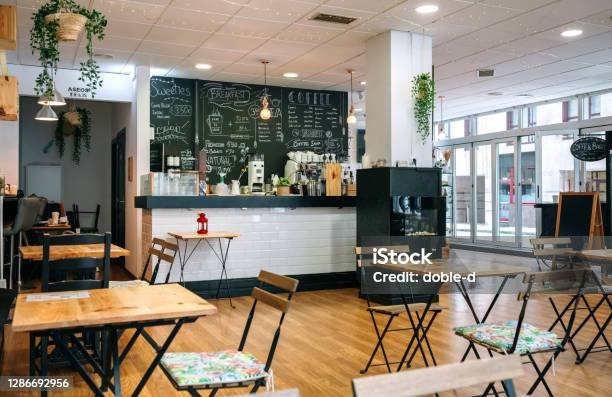 Empty modern cafe interior with chairs and tables